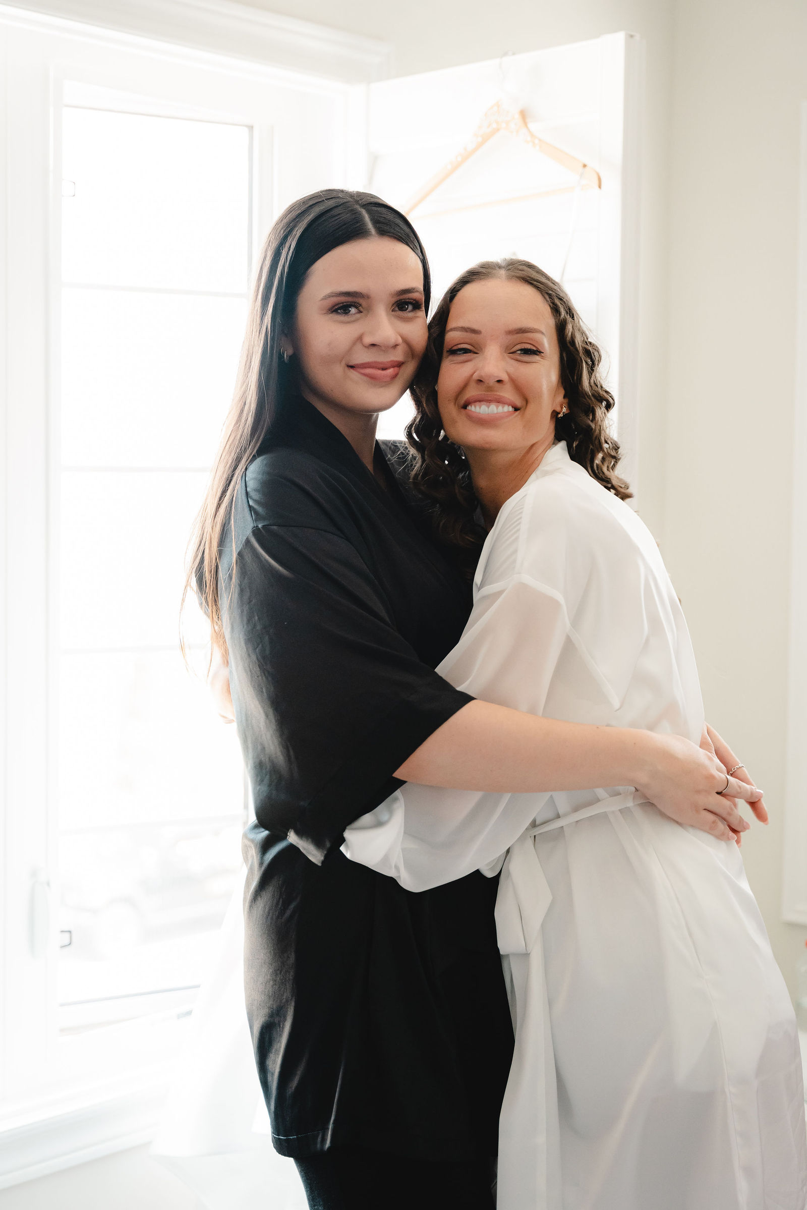 Bride and friend share a hug
