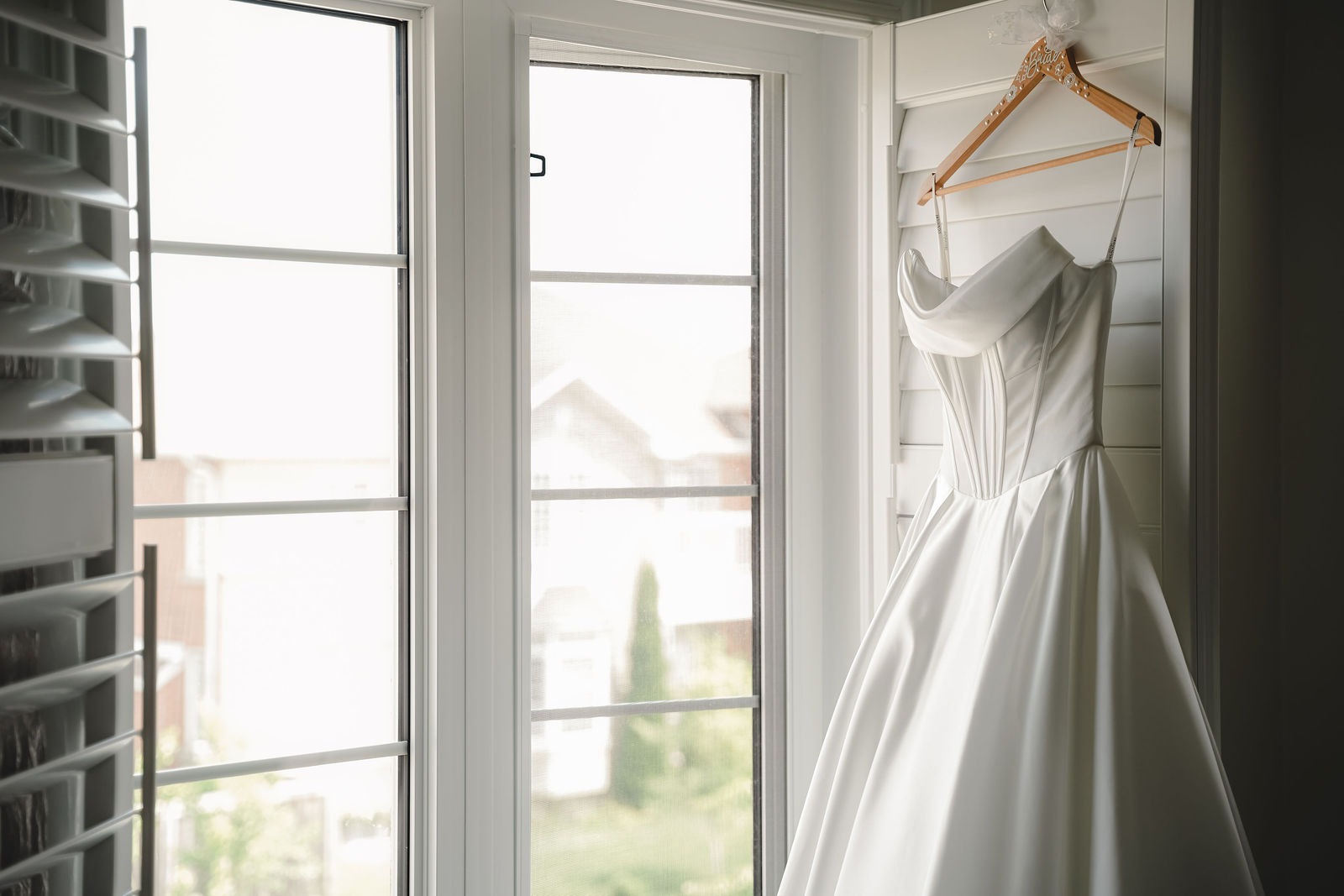Ivory gown glowing in the window