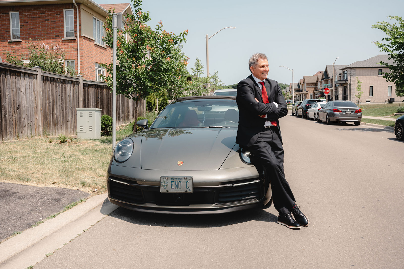 Father proud beside the car