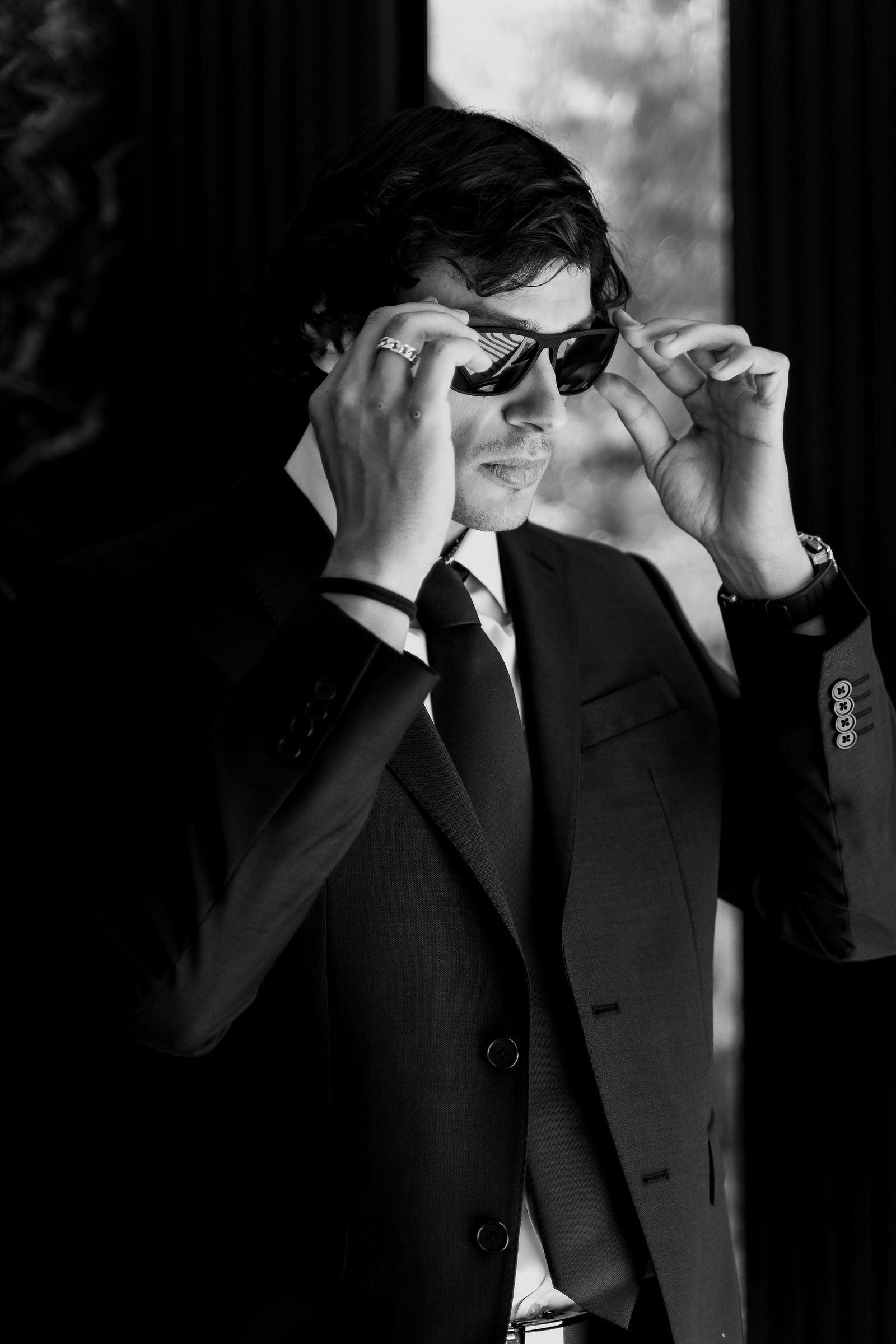Black-and-white groom, sunglasses and suit