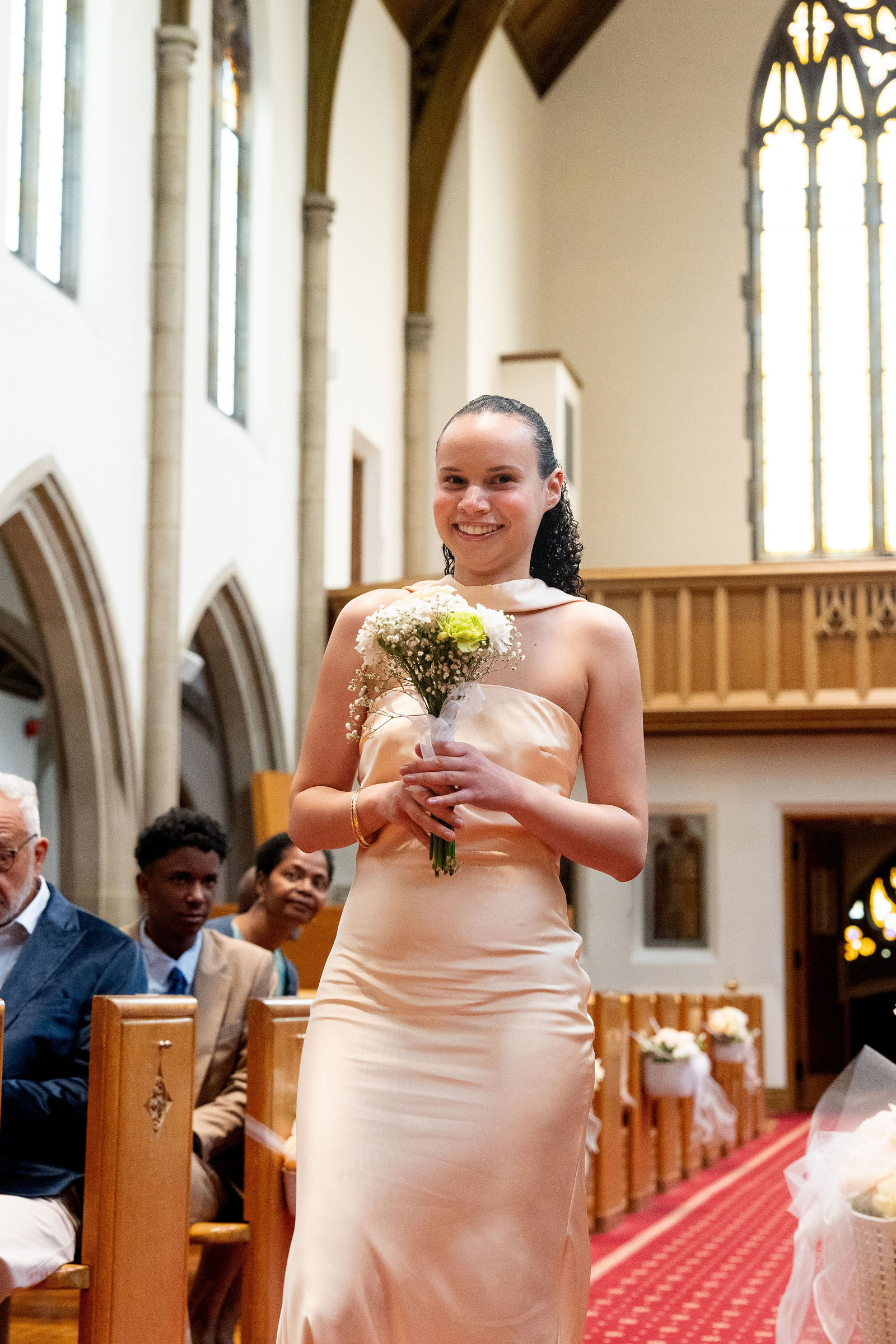 Bridesmaid glowing down the aisle