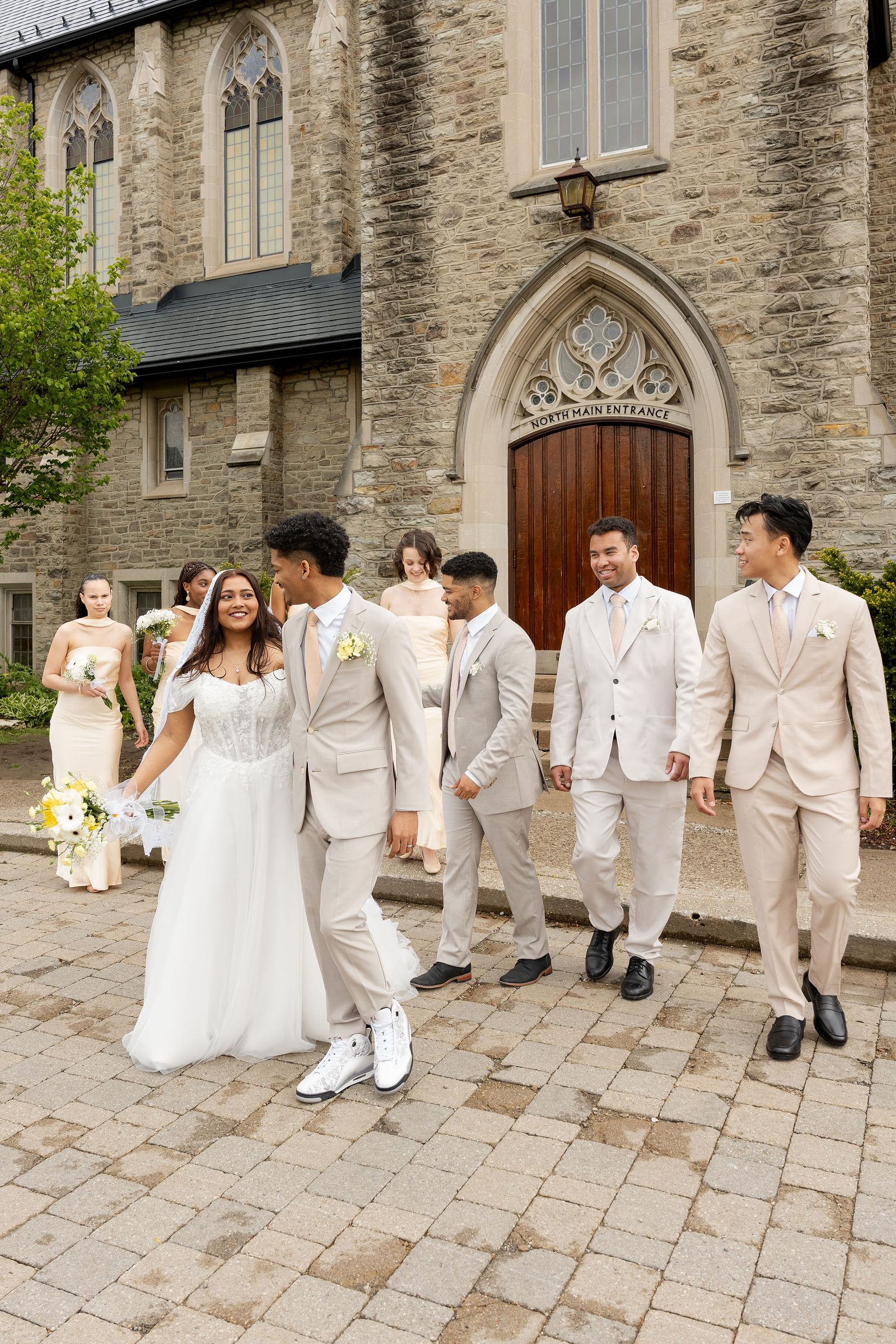 Bridal party striding from the church
