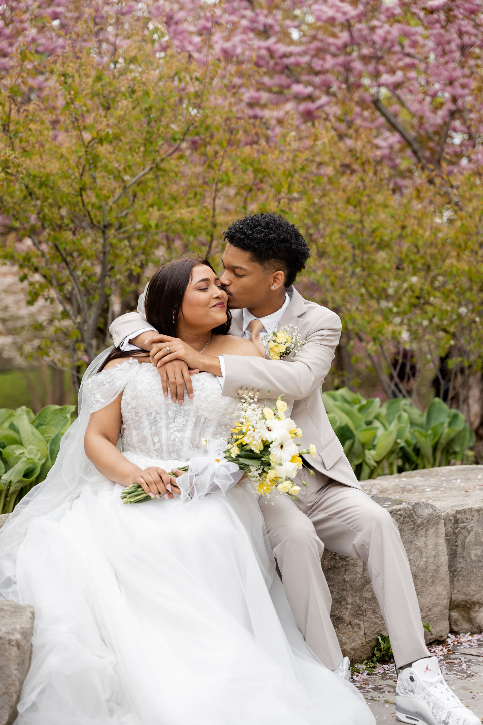 A kiss beneath blossoming boughs