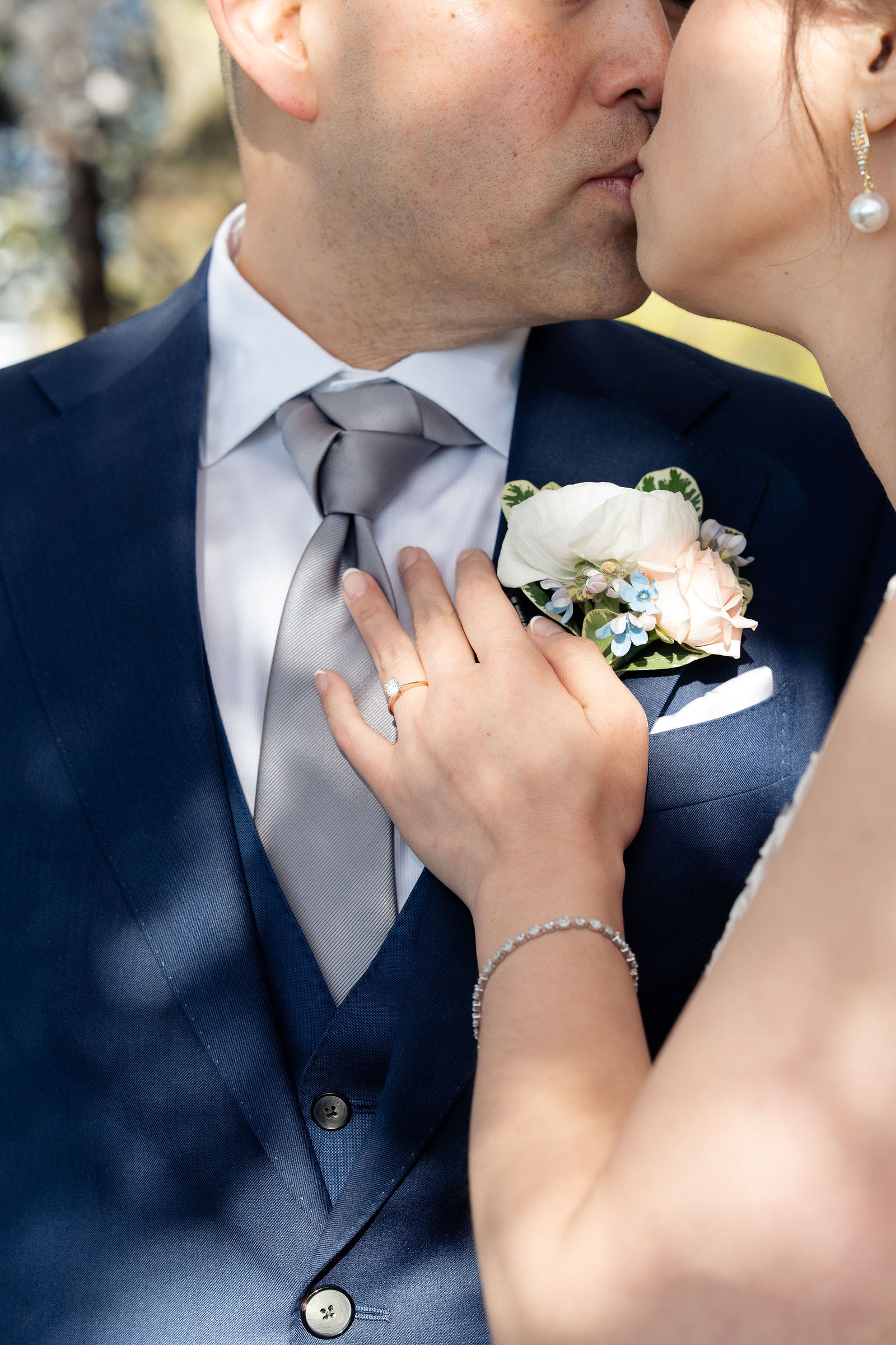 Soft kiss, ring on boutonniere