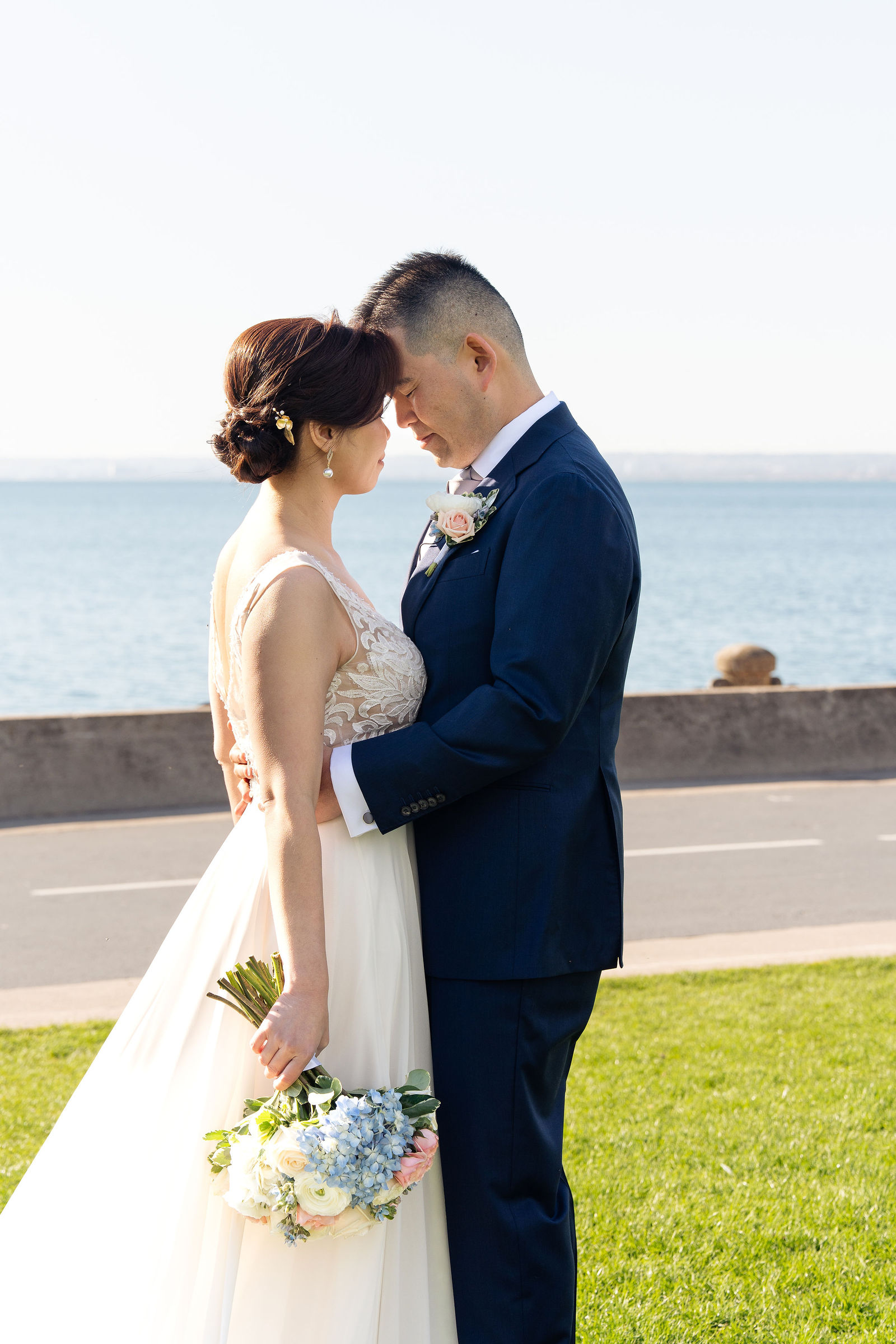 Foreheads together, water stretching behind