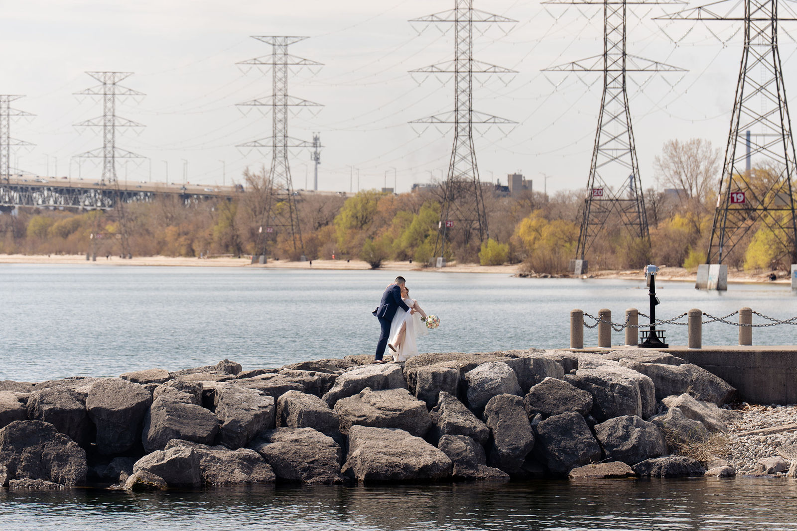 Tiny on the breakwater, vast lake