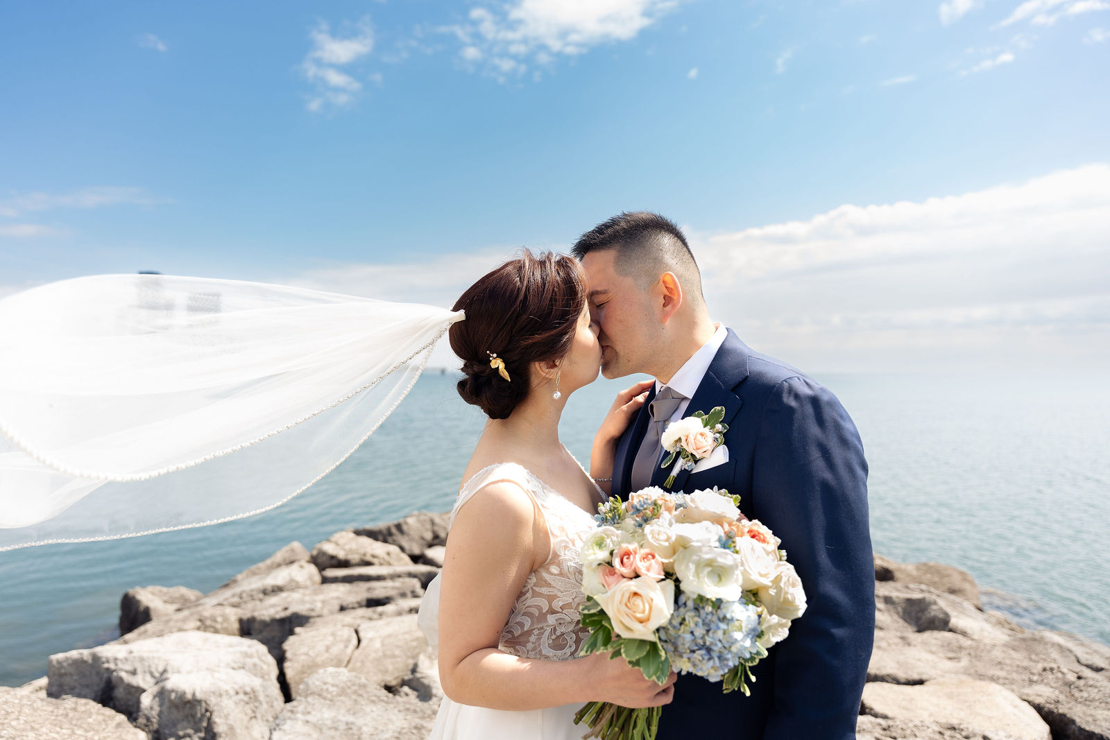 A kiss on the breakwater, lake wide behind