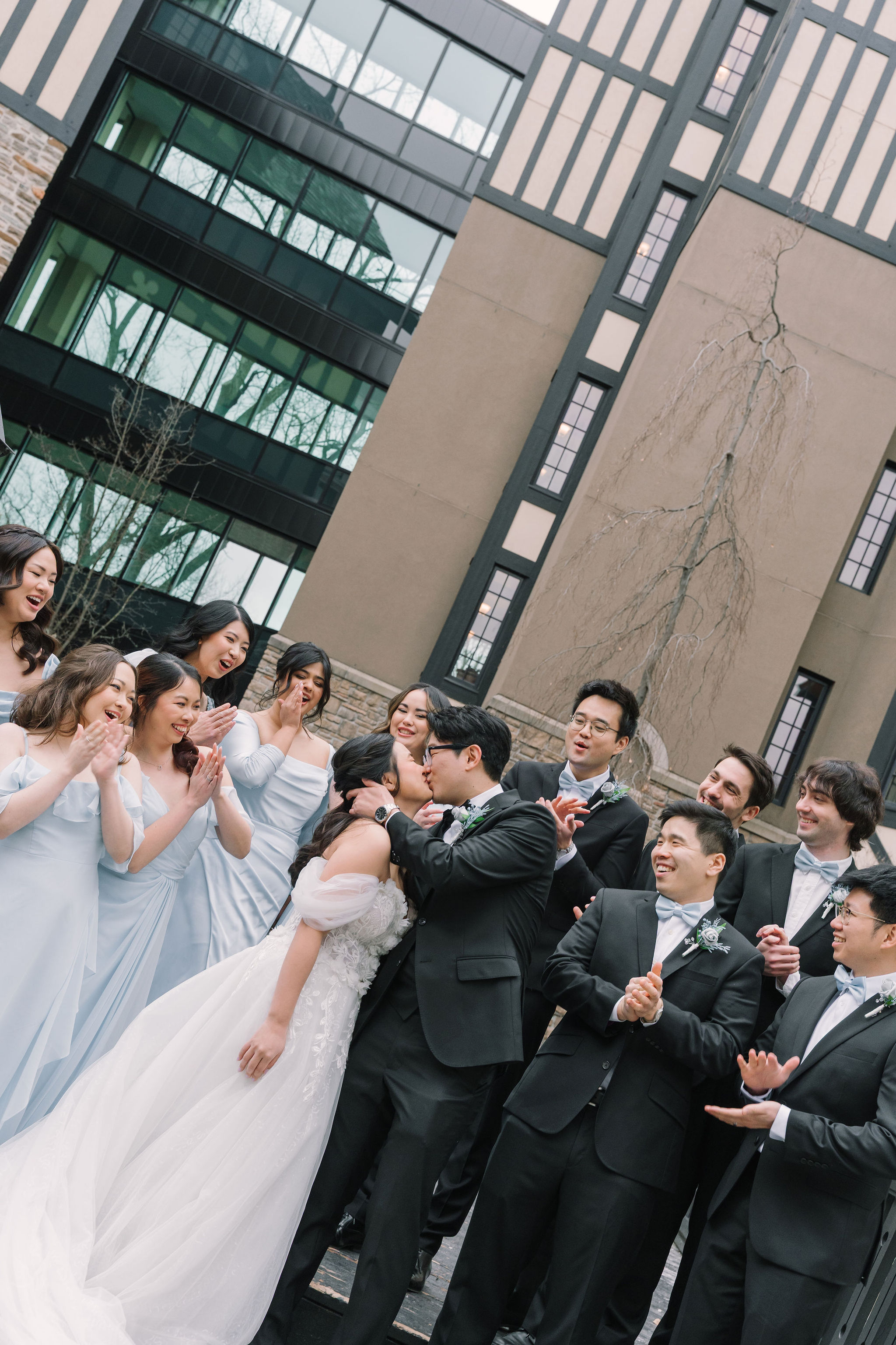 Wedding party celebrates a kiss