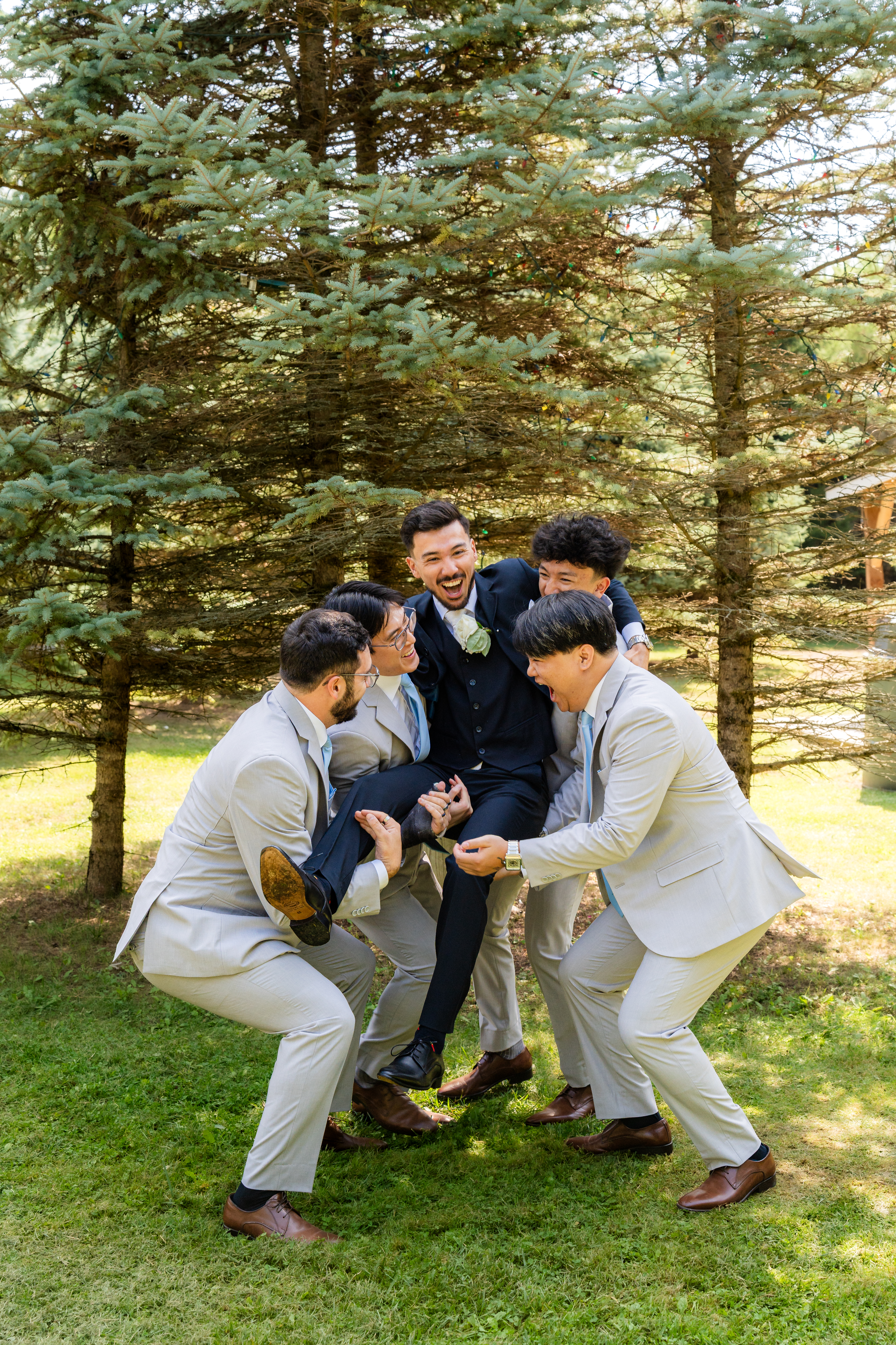 Groomsmen lifting groom