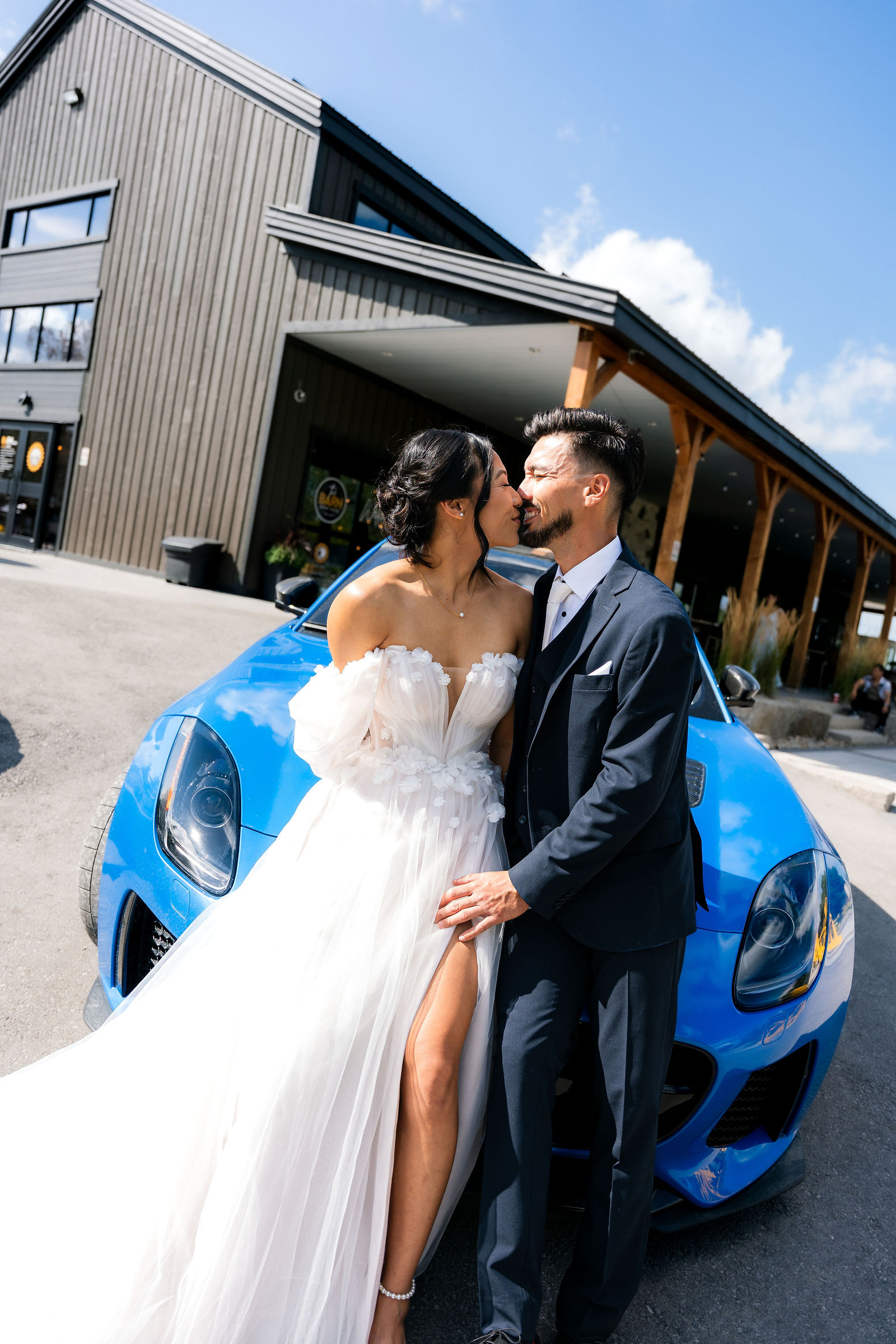 A kiss beside the blue car