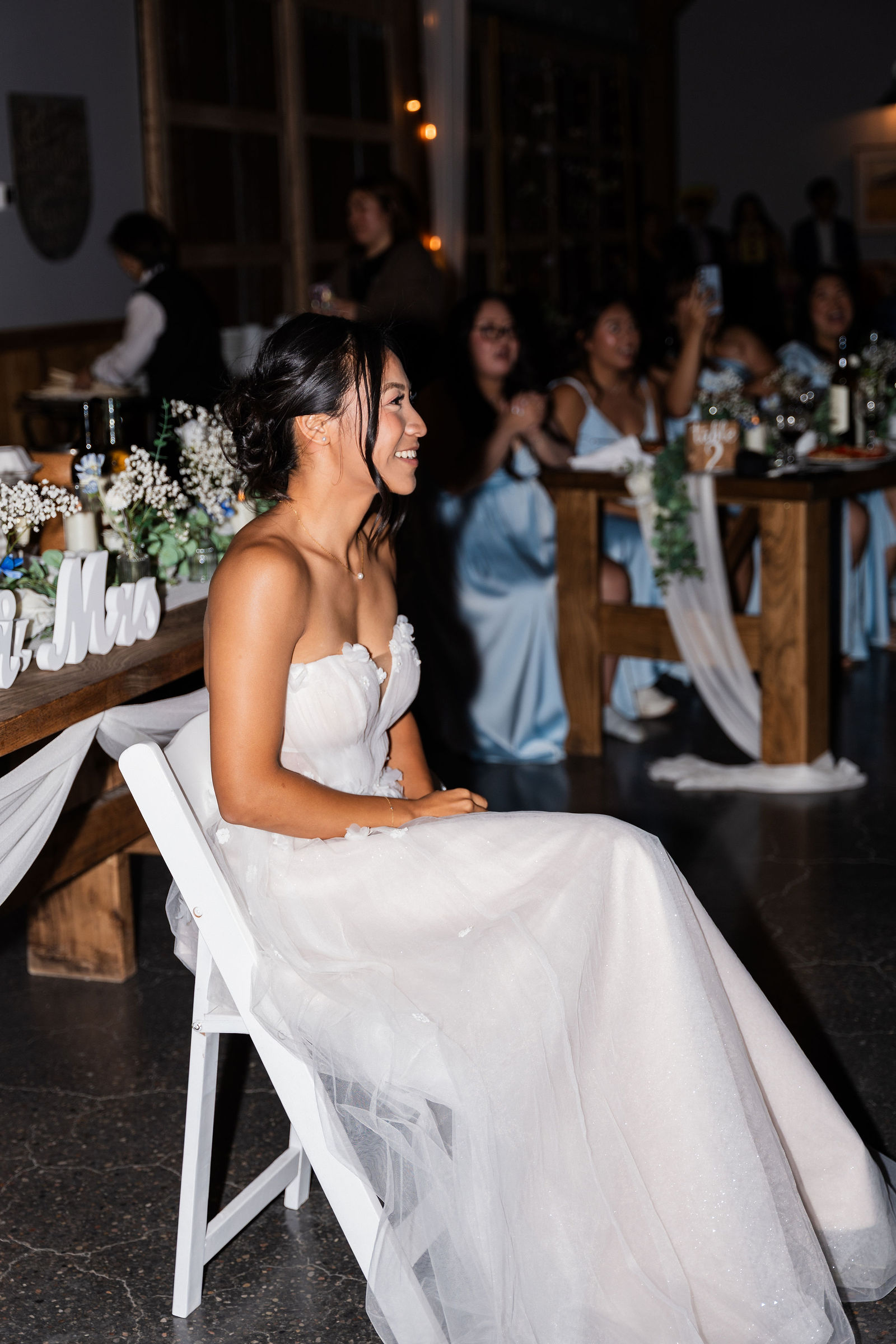 Bride laughing, radiant in her chair
